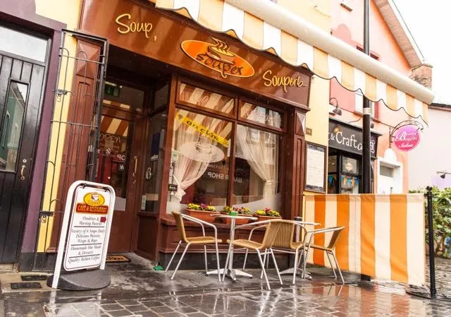 Original Souper Cafe branding with striped awning and outdoor tables